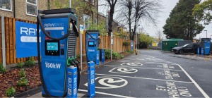 EV charging site with blue RAW charging branding, in a car park